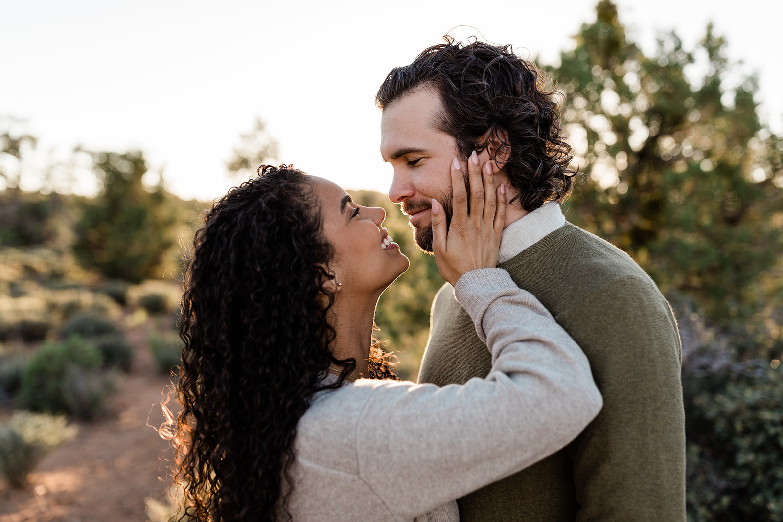 closeup on couple kissing during adventure engagement session