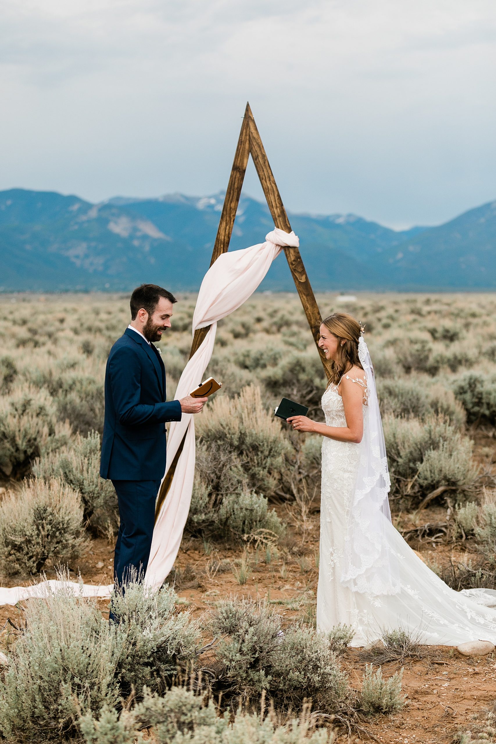 bride and groom reading vows to each other in taos new mexico elopement
