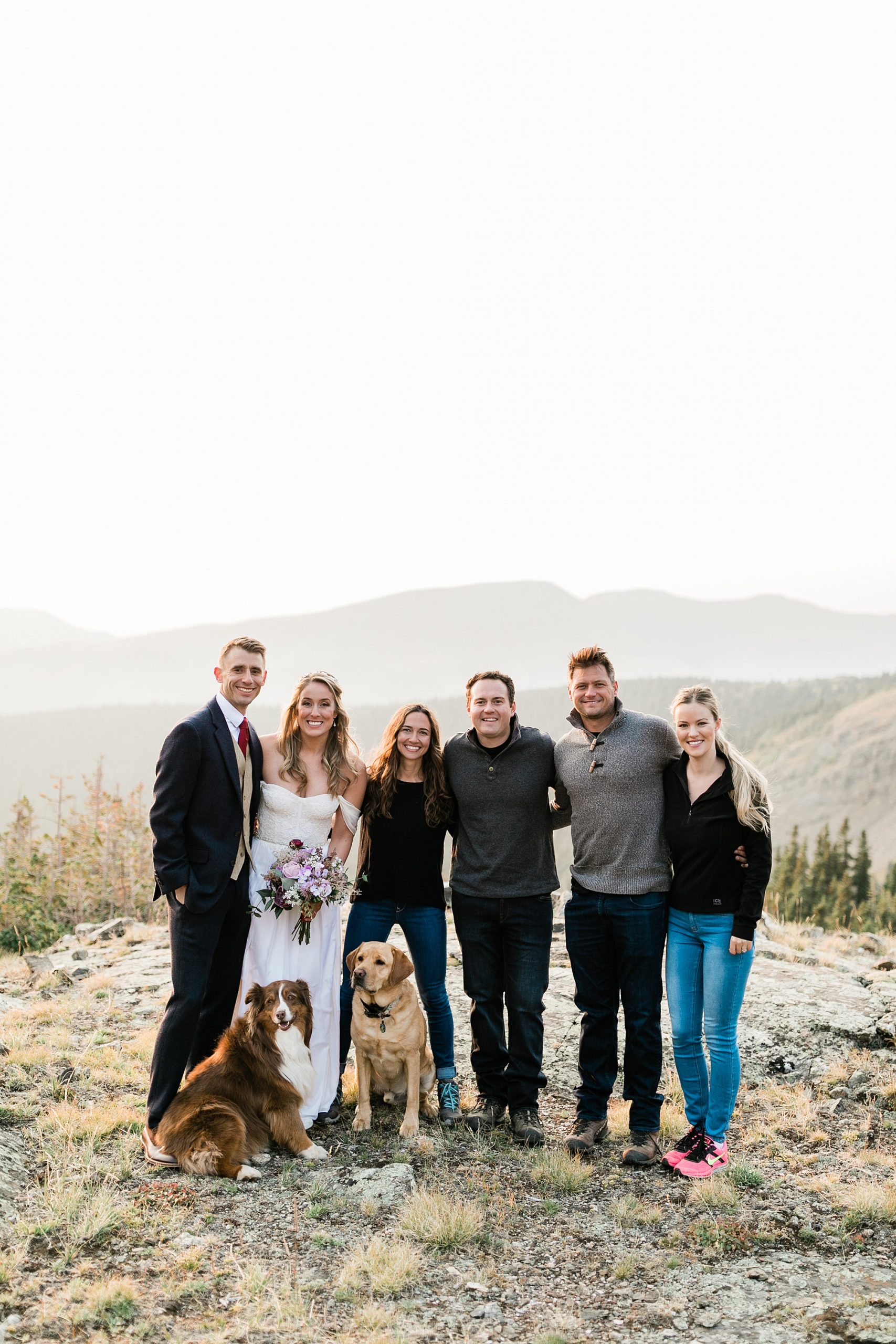 group photo in the mountains with  bride and groom