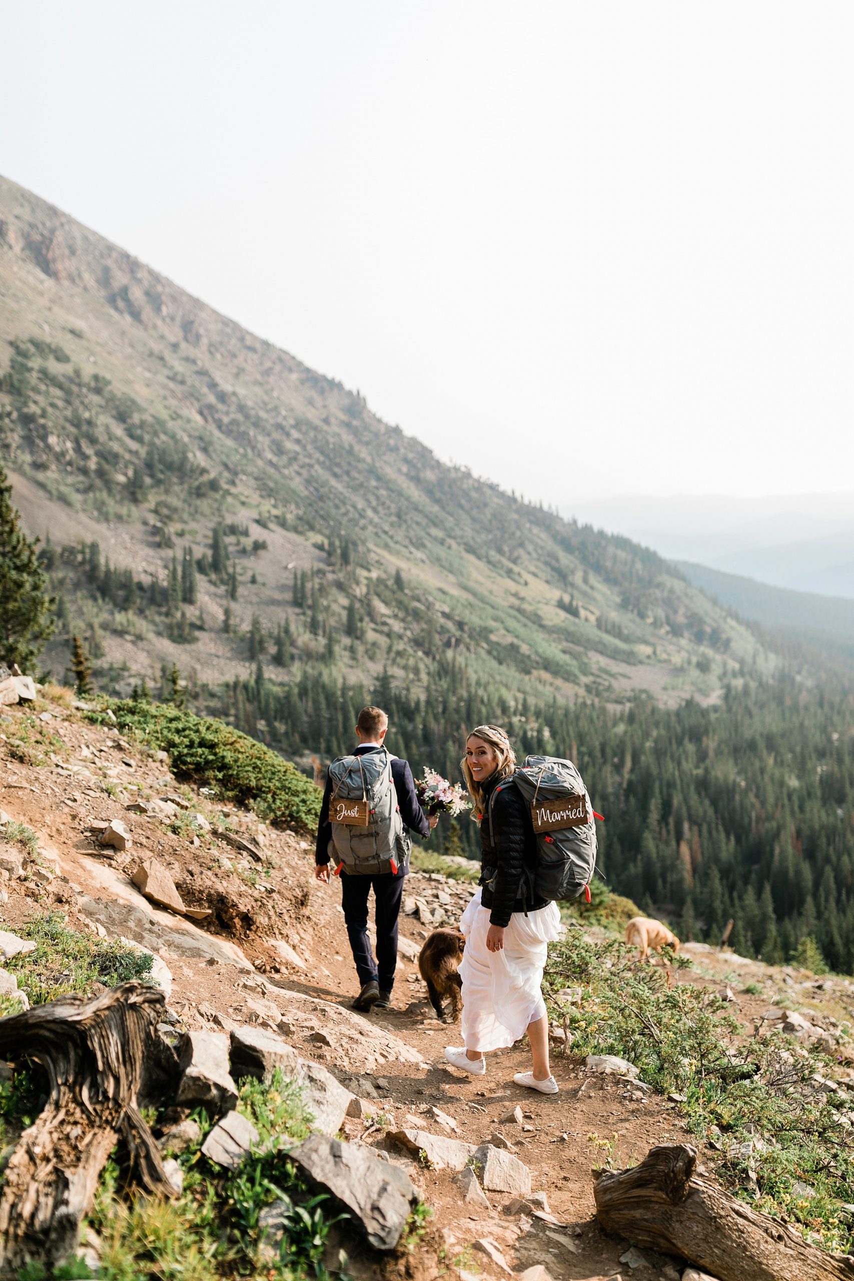 colorado hiking elopement just married signs on back packs
