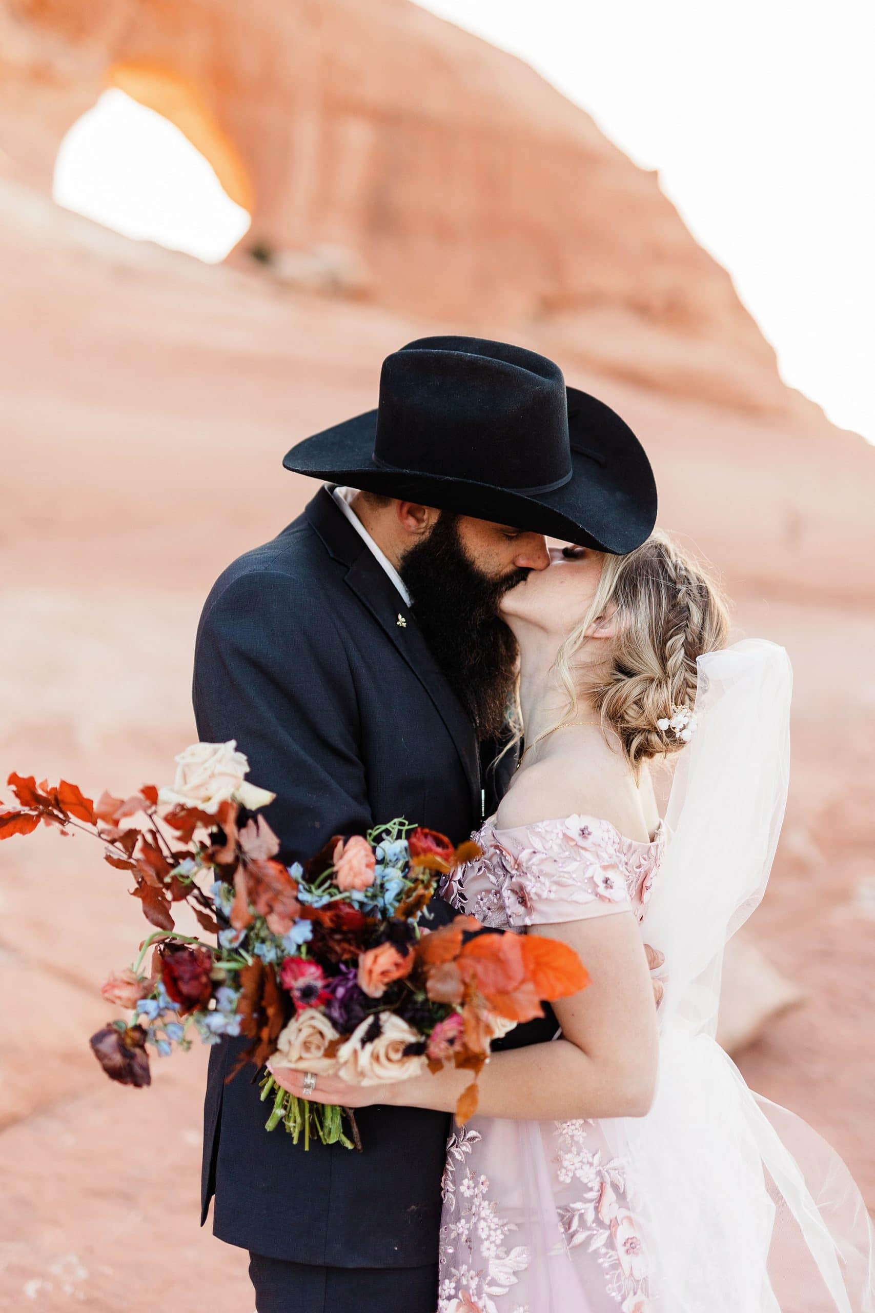A bride and groom kiss after they elope in Moab.