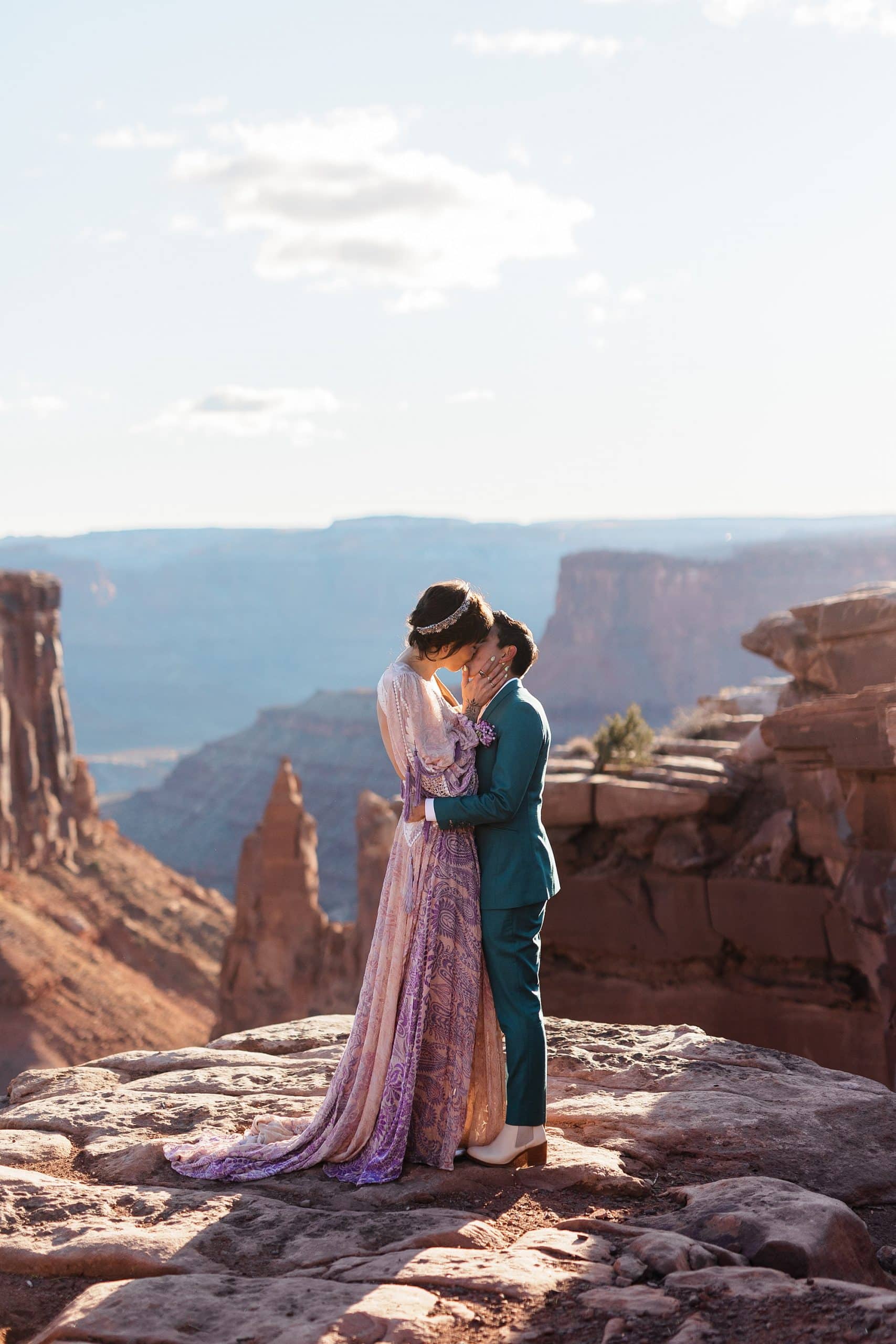 A couple kisses at Marlboro Point after they elope in Moab.