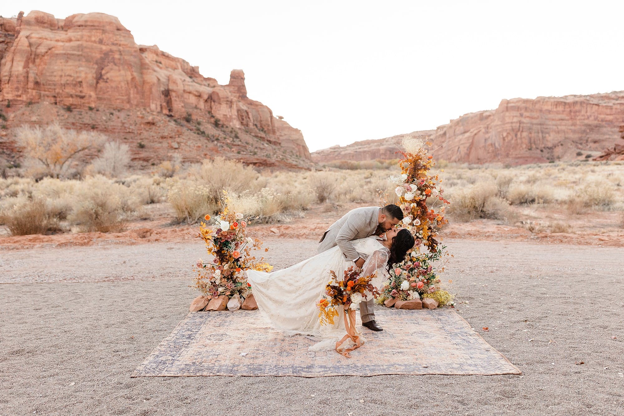 A groom dips his bride in Moab.