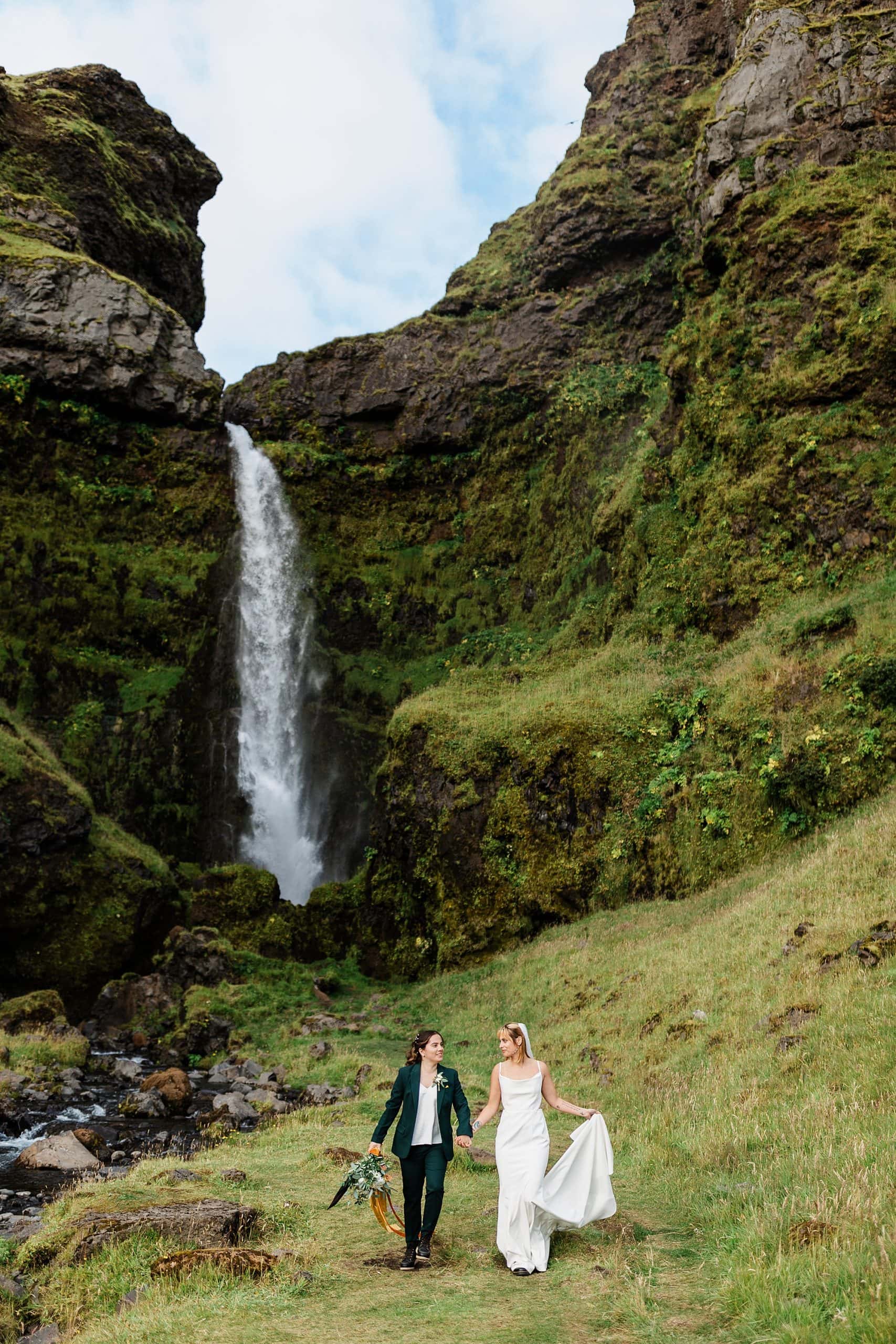 A couple elopes in Iceland near a beautiful waterfall