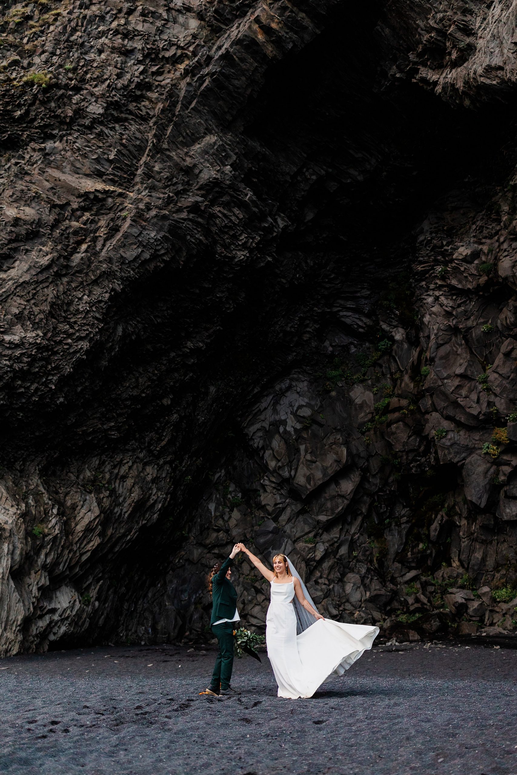 A couple dances at Black Sand Beach after they get married
