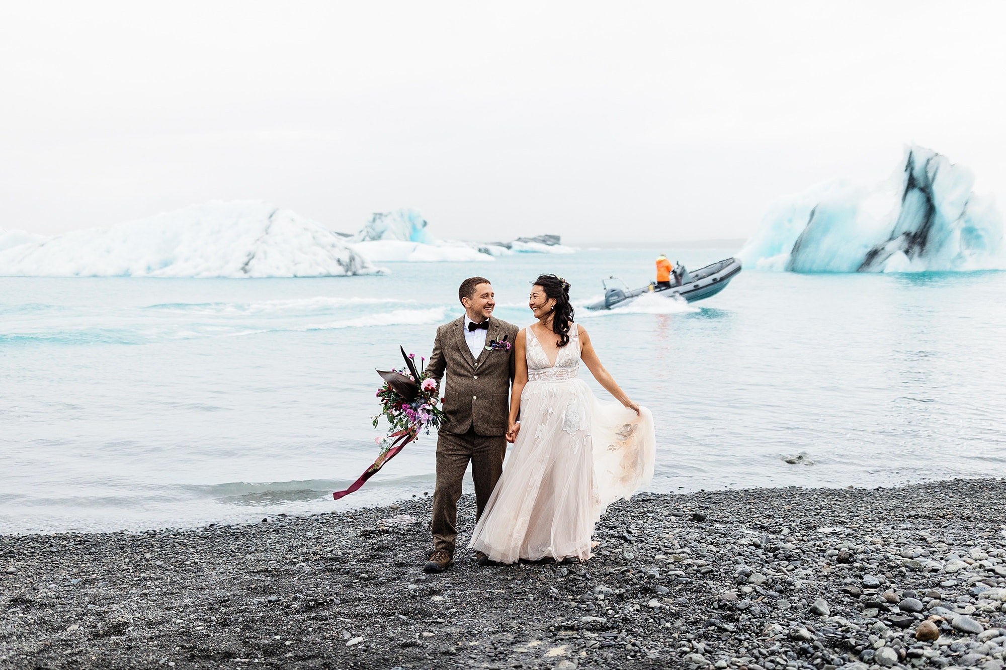 A bride and groom admire one another at Diamond Beach near icebergs in Iceland