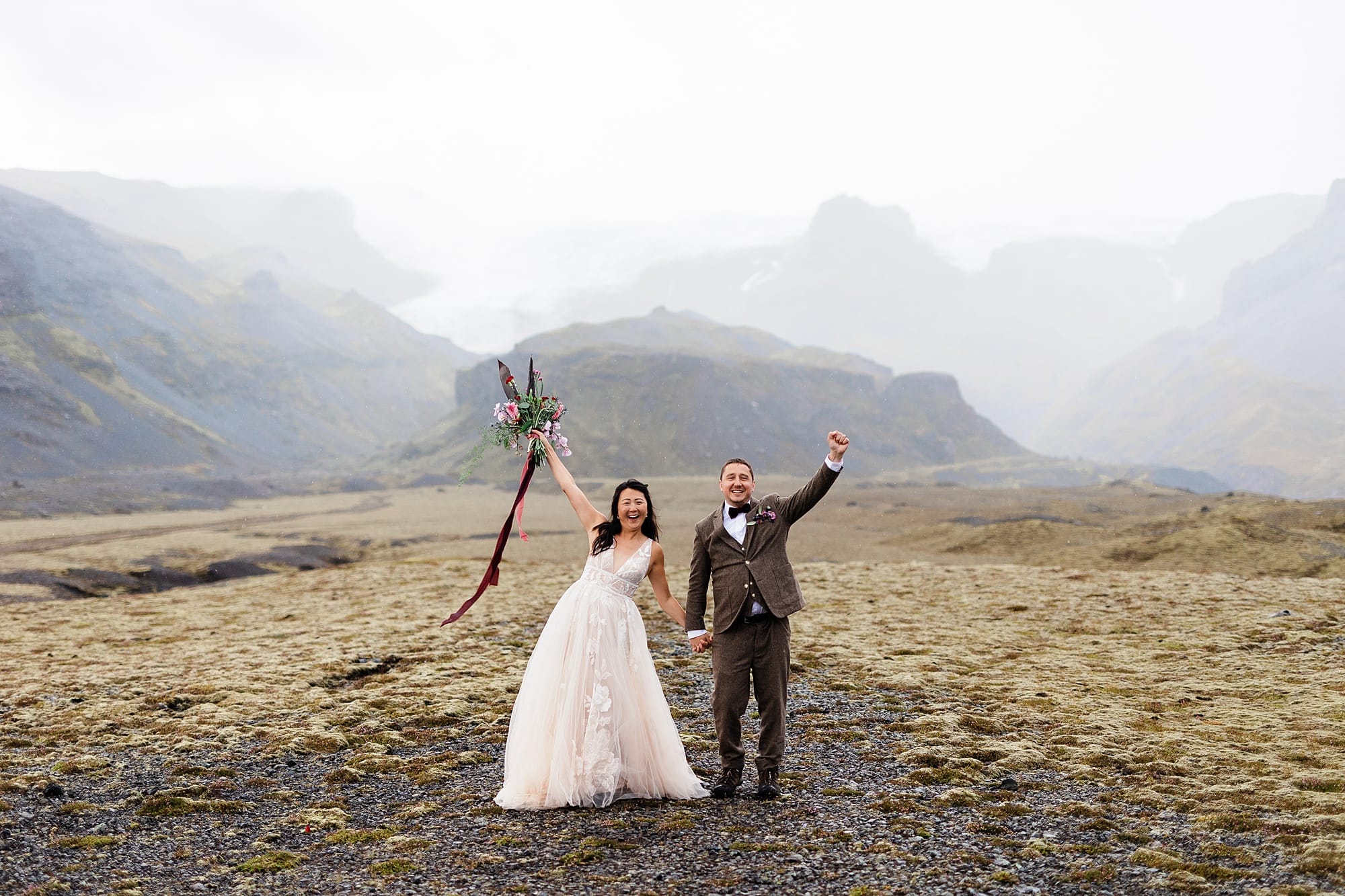 A couple celebrates their elopement with cheers while in Iceland 