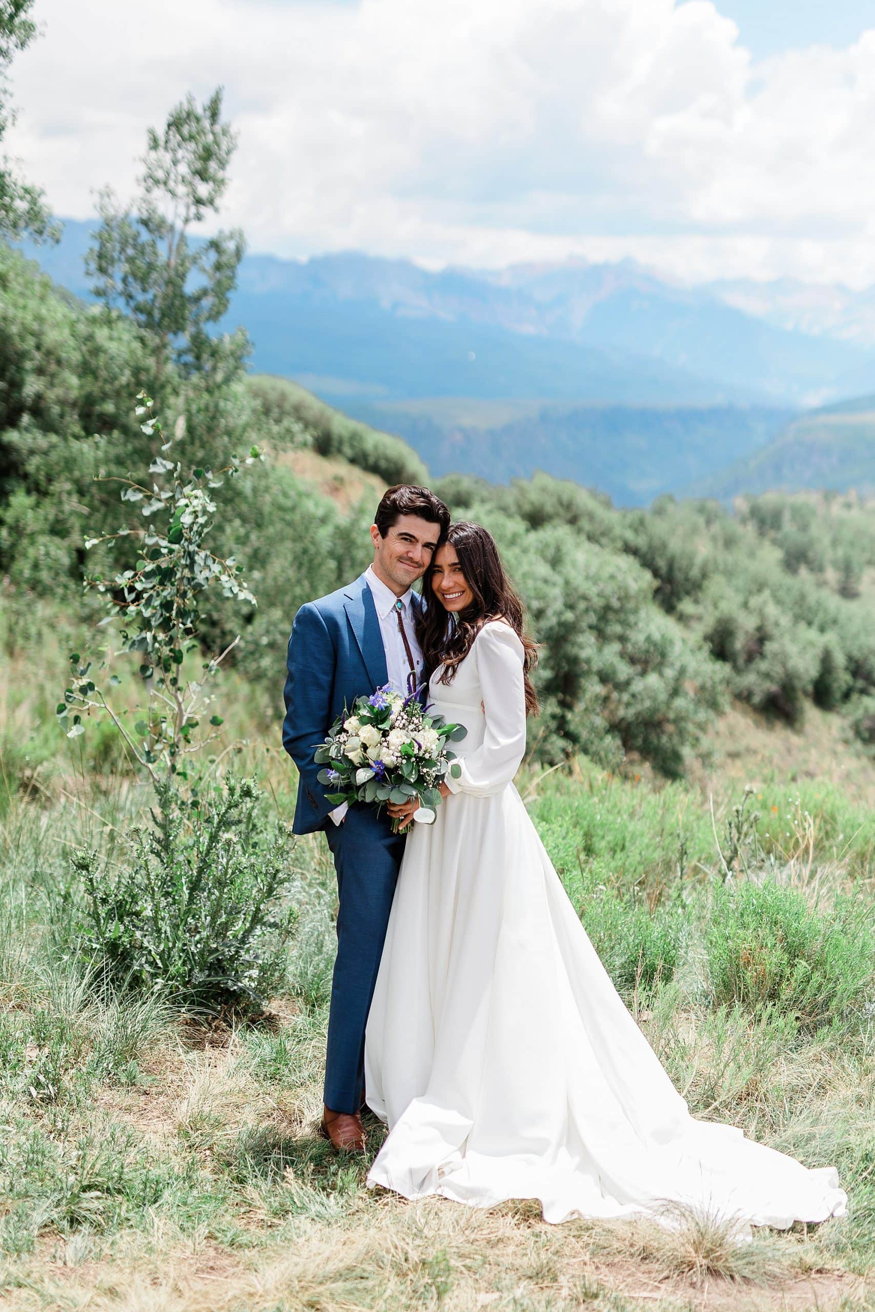 A couple that just eloped poses with florals in Telluride