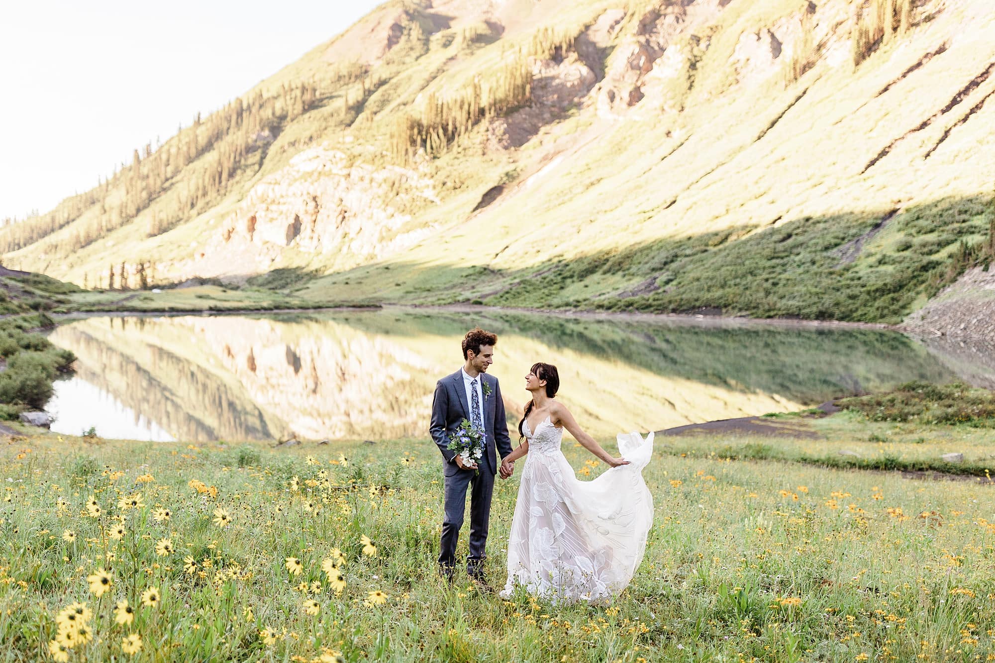 A couple that's just eloped stands in a field of wildflowers in Crested Butte