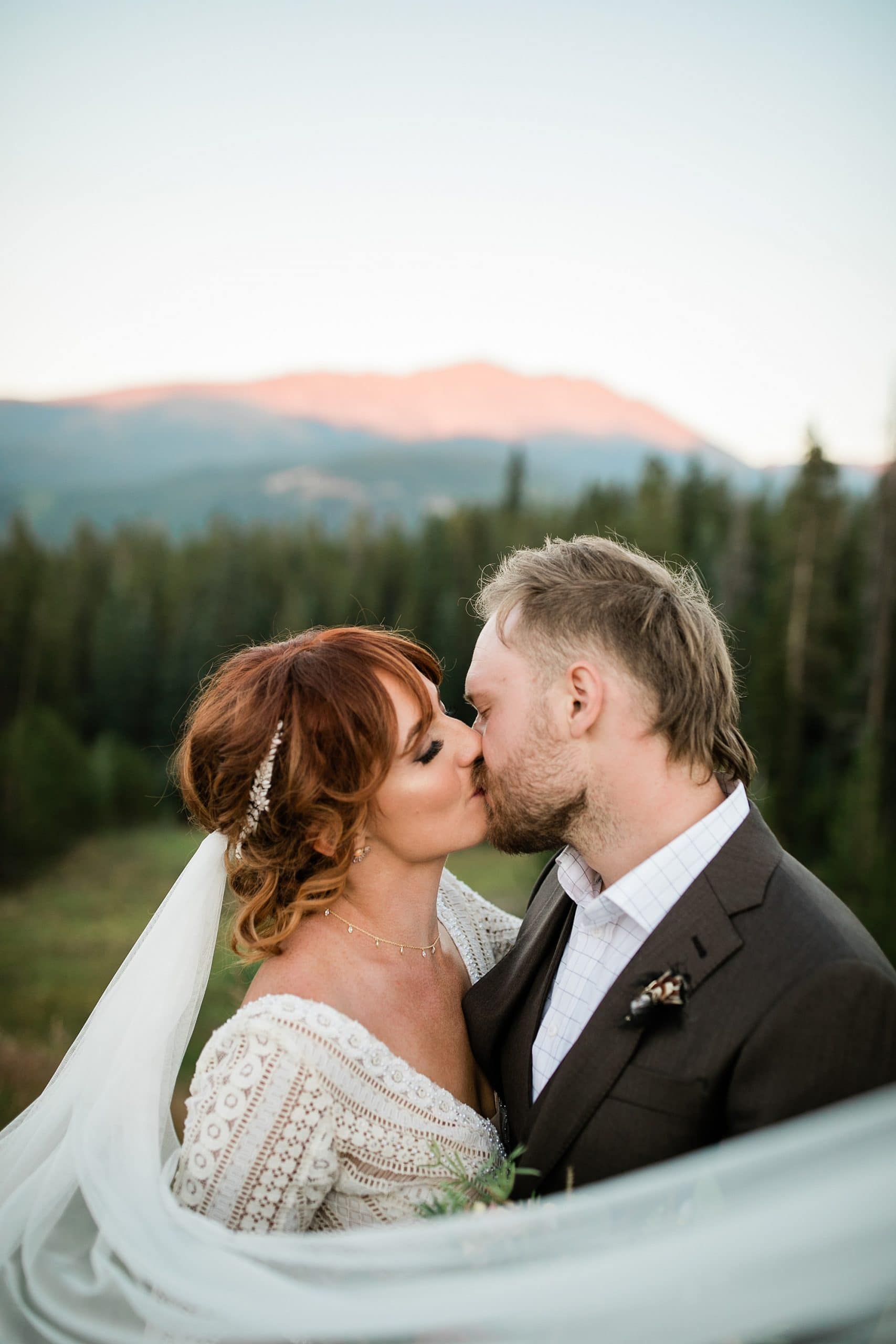 A bride and groom kiss during their elopement in Colorado