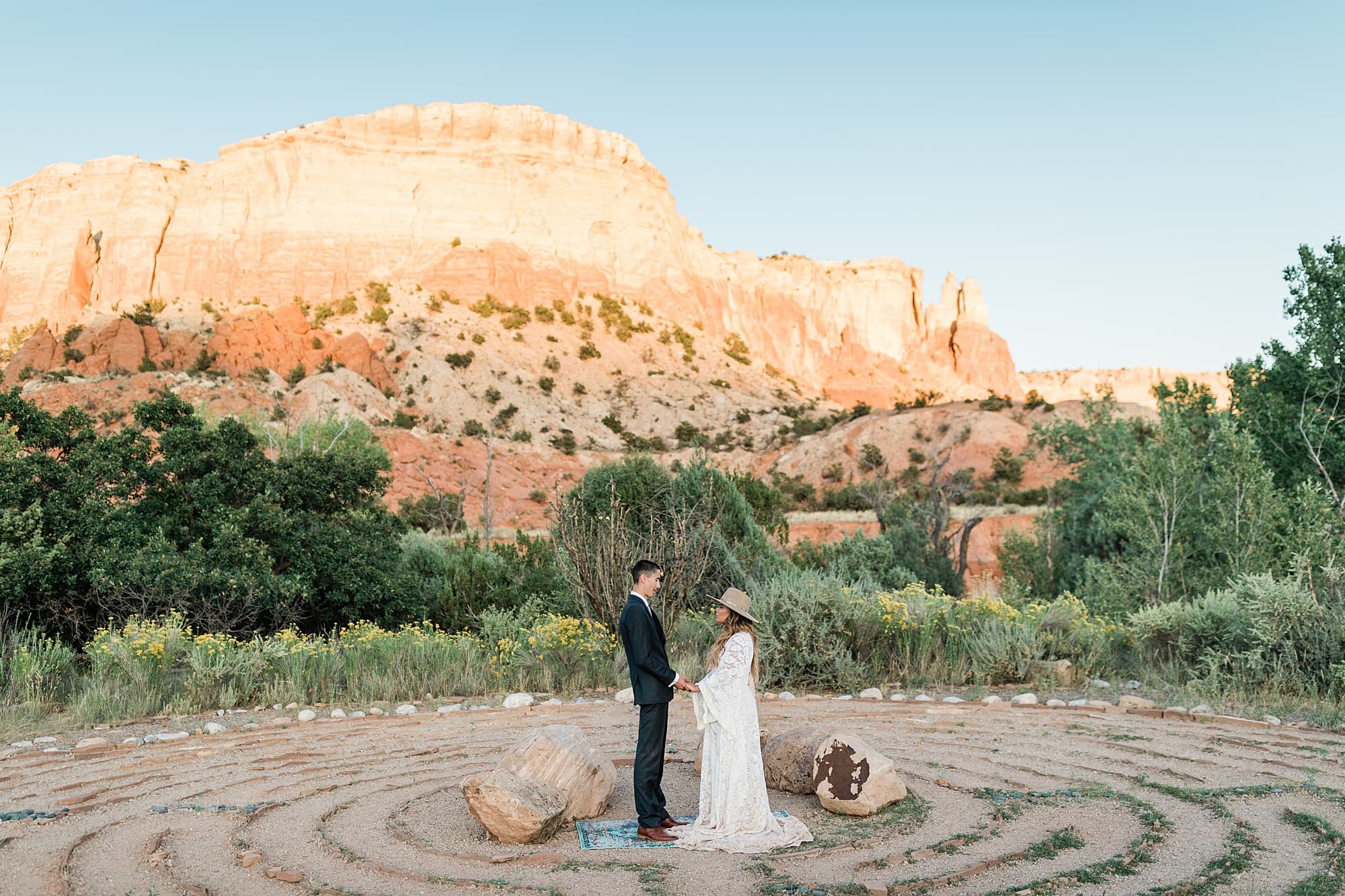 A beautiful couple stands near a mountain-scape in New Mexico for their elopement