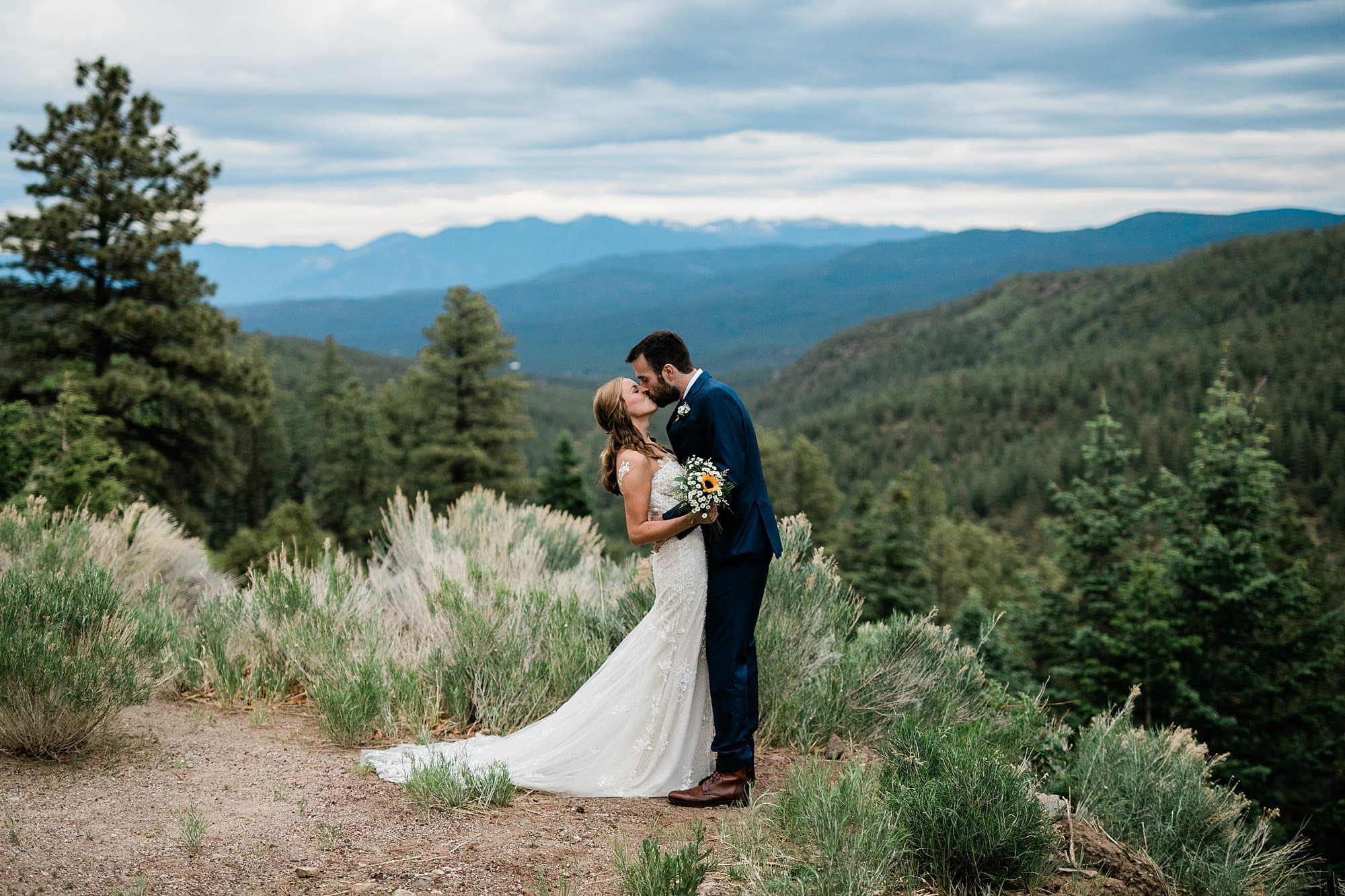 A couple kisses in the mountains of Taos, New Mexico.