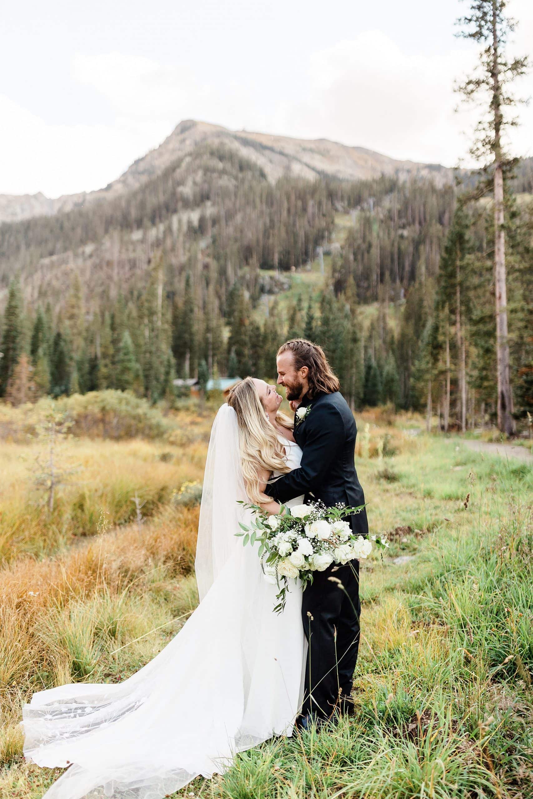Newlyweds share a laugh after their Summer elopement in Taos Ski Valley.