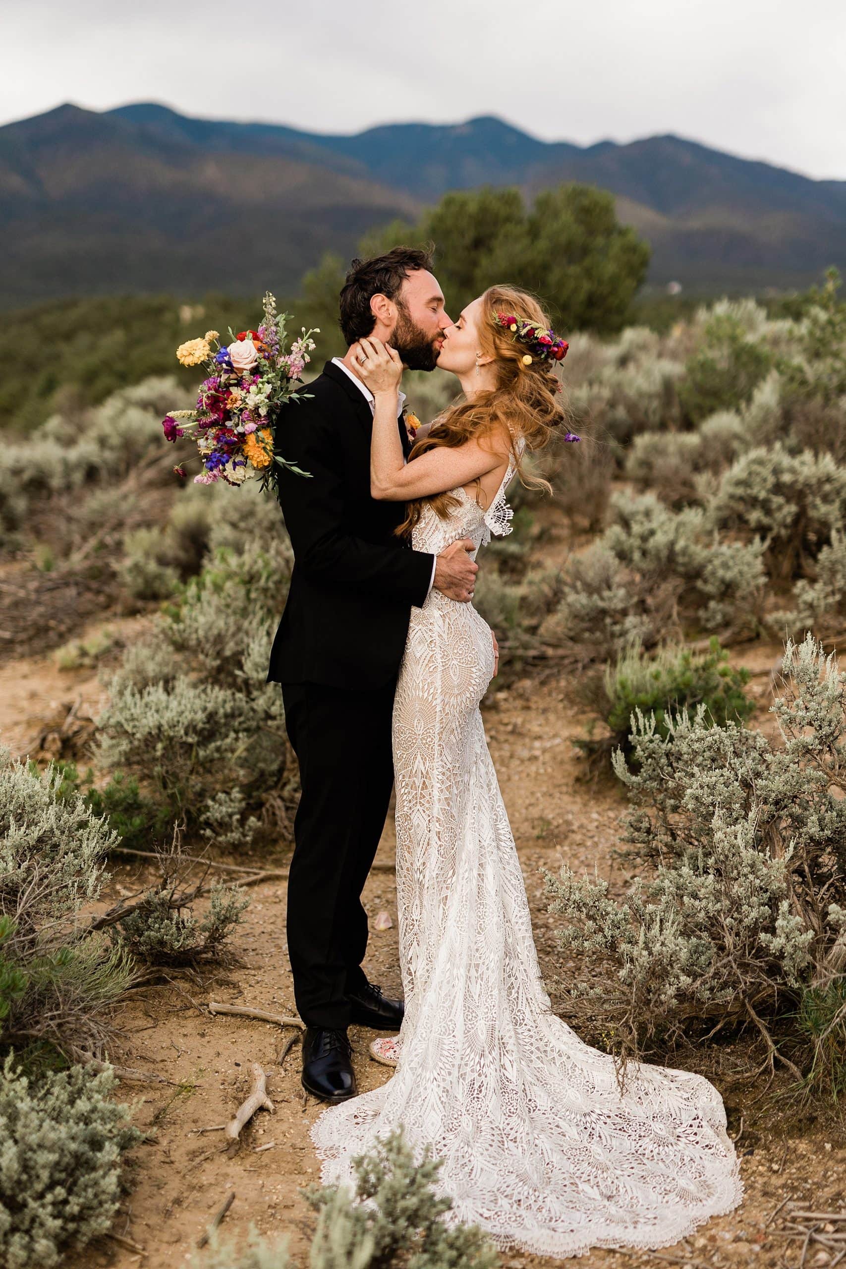 A bride and groom kiss after their intimate wedding at a goji farm in Taos. 