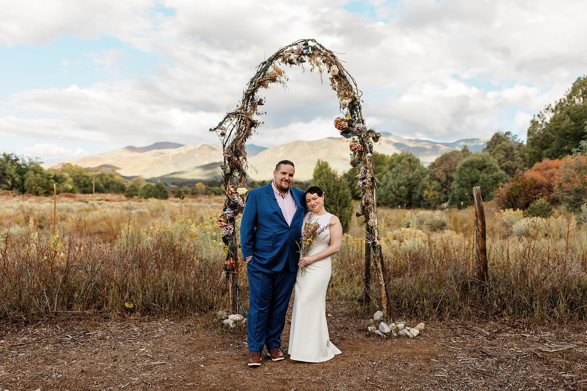 Newlyweds smile for the camera after a wedding in Taos. 