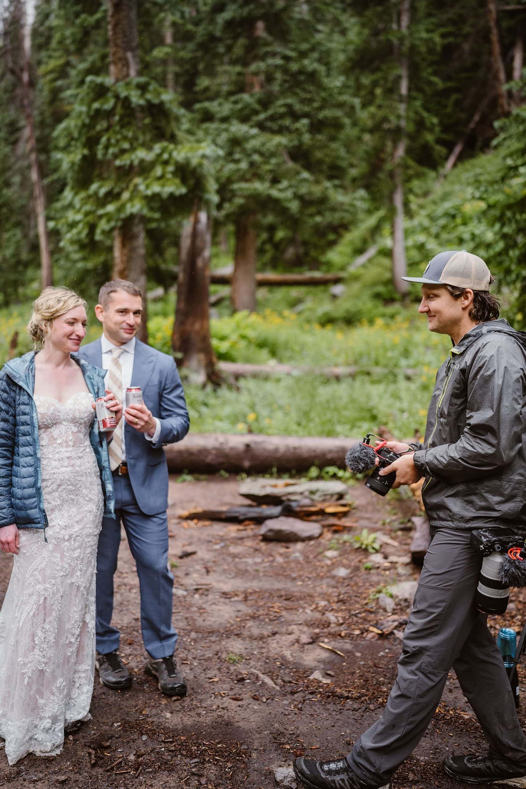 An elopement videographer is seen with a bride and groom at an adventure elopement ceremony