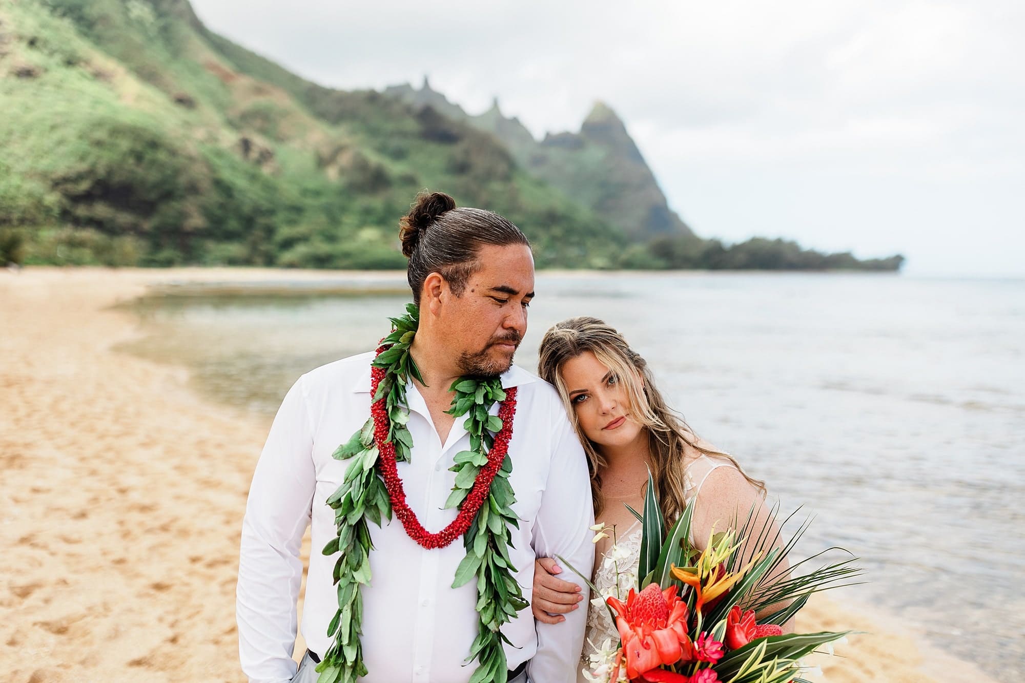 A wife rests her head on her husband's shoulder after their elopement in Hawaii